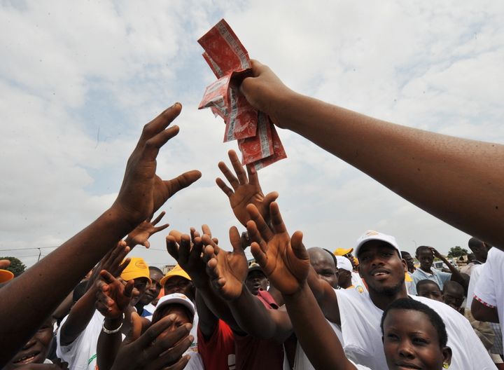 A young woman hands over condoms in Yopougon, a working district of the capital city Abidjan on September 28, 2009, as part of an AIDS prevention programme for 5 millions people on an Abidjan-Lagos axis including five West African countries: Ivory Coast, Ghana, Togo, Benin and Nigeria.