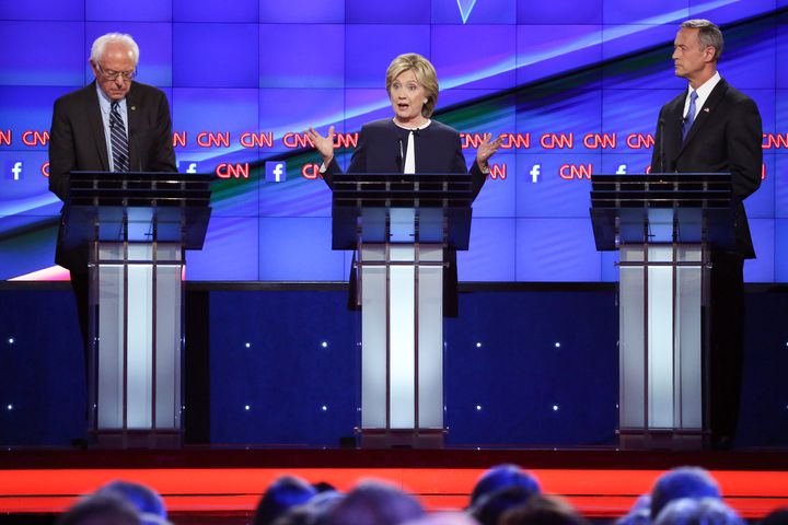 Sen. Bernie Sanders (I-Vt.), former Secretary of State Hillary Clinton and former Maryland Gov. Martin O'Malley at the first presidential debate in October. It will fall to Clinton at the debate on Saturday to explain why her $12 an hour wage goal makes more sense than $15.