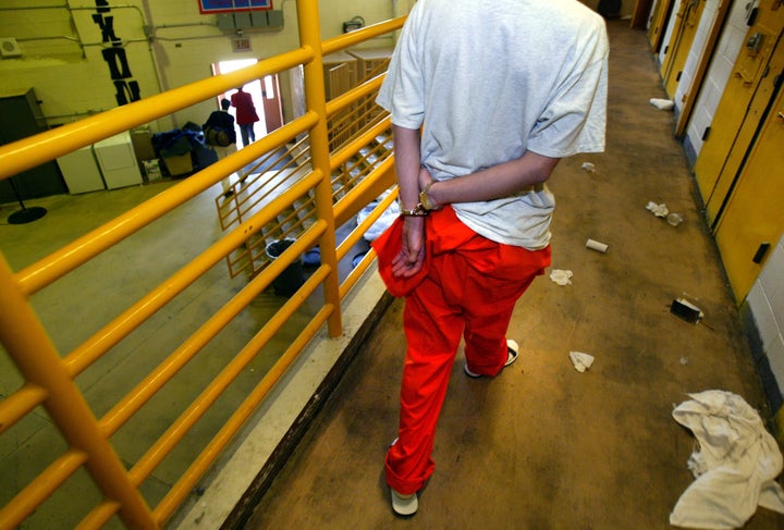 A young offender walks handcuffed from his cell at the Nixon facility at the Fred Nelles CYA facility in Whittier, California, which is now closed. 