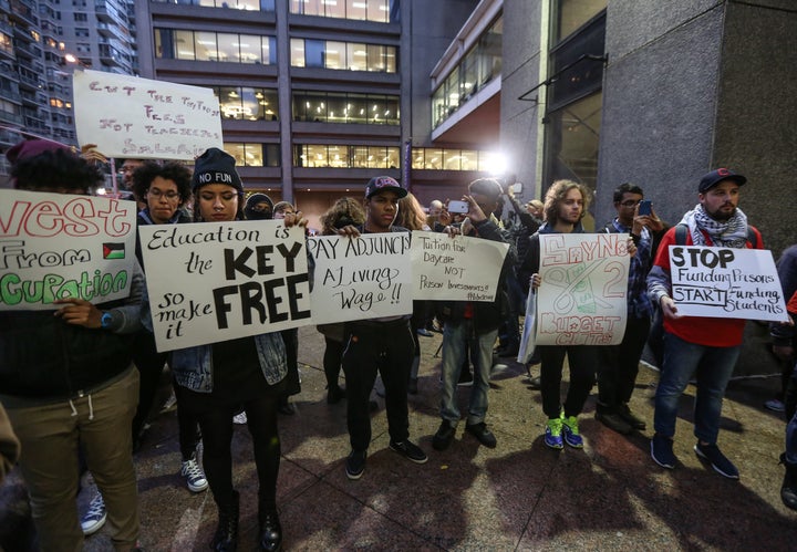 NEW YORK, NY - NOVEMBER 13: Students hold placards as they stage a demonstration at the Hunter College, which is a part of New York City University, to protest ballooning student loan debt for higher education and rally for tuition-free public colleges in New York on November 13, 2015. (Photo by Cem Ozdel/Anadolu Agency/Getty Images) 