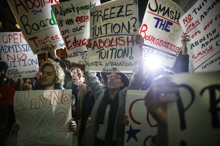 NEW YORK, NY - NOVEMBER 13: Students hold placards as they stage a demonstration at the Hunter College, which is a part of New York City University, to protest ballooning student loan debt for higher education and rally for tuition-free public colleges in New York on November 13, 2015. (Photo by Cem Ozdel/Anadolu Agency/Getty Images) 