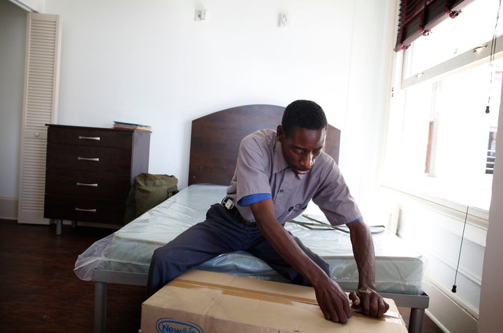 Army Veteran, Anthony Smith, 49, who served in Desert Storm in Iraq, opens a fan given to him in his new apartment inside the Historic Rosslyn Hotel. 