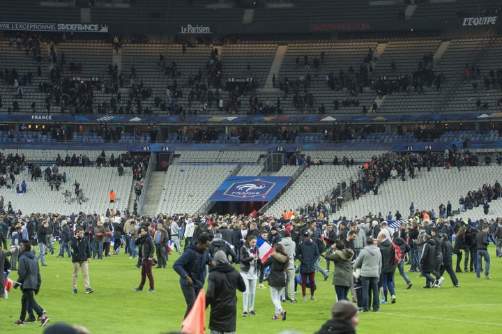 Supporters run in panic on the pitch during the friendly match between France and Germany at the Stade France in Paris, France.