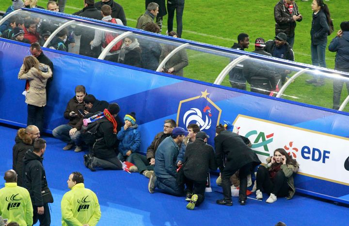 Spectators wait on the pitch during the game between France and Germany at Stade de France on November 13, 2015 in Paris, France. The game was halted following an explosion in the stadium and attacks across Paris claiming the lives of numerous people. (Photo by Xavier Laine/Getty Images)