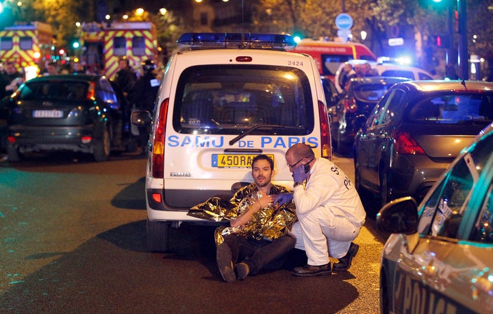 A medic tends to a man November 13, 2015 in Paris, France. Gunfire and explosions in multiple locations erupted in the French capital. (Photo by Thierry Chesnot/Getty Images)