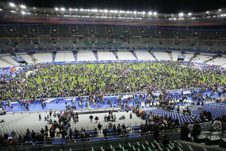 Spectators on the field after the explosions near the stadium.