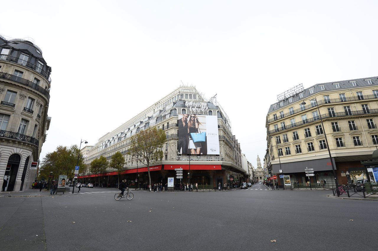 The street outside the landmark Galleries Lafayette department store in Paris stands largely deserted on Nov. 14, 2015, as many places remain closed.