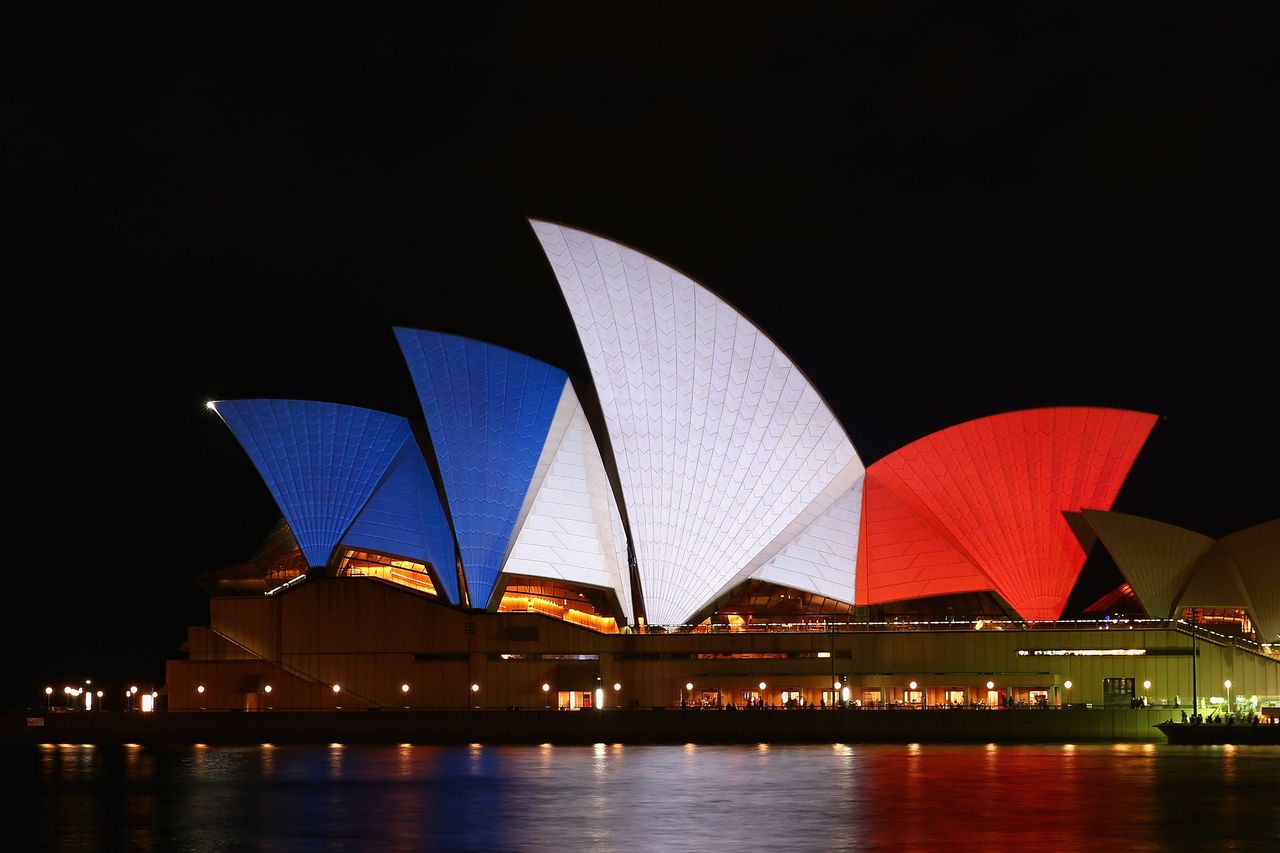 The sails of the Sydney Opera House are illuminated in the colors of the French flag on Nov. 14, 2015, in Sydney, Australia.