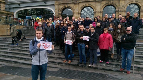 People gather for a vigil outside Liverpool Lime Street station following terror attacks in Paris.