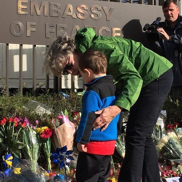 A family pays respects outside the French Embassy in Washington, D.C. on Saturday, Nov. 14, 2015.