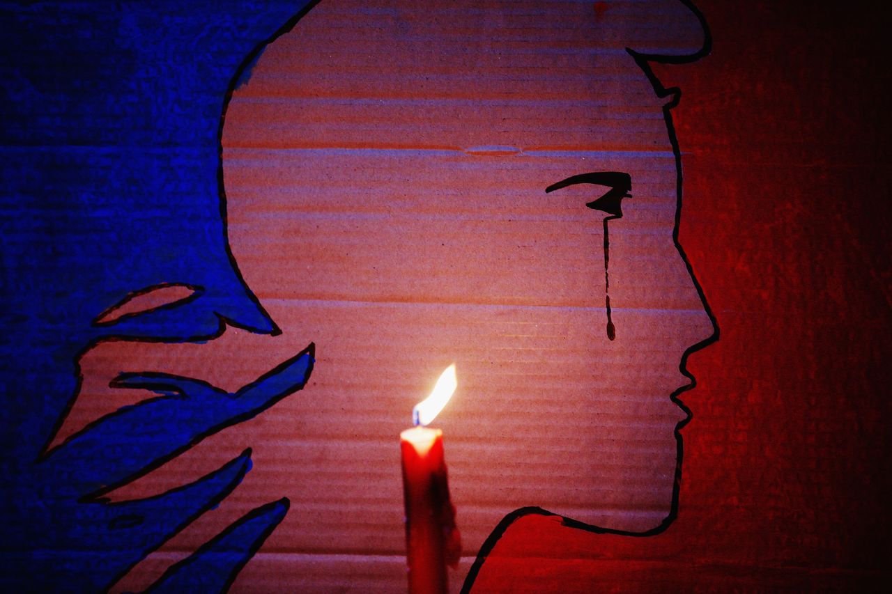 A candle burns during a vigil in Aotea Square to remember victims of the Paris attacks on Nov. 14, 2015 in Auckland, New Zealand. 