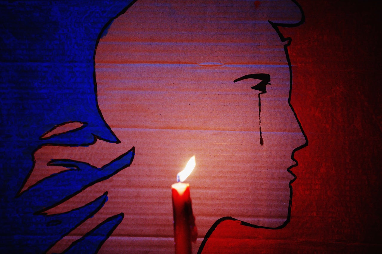 A candle burns during a vigil in Aotea Square to remember victims of the Paris attacks on Nov. 14, 2015 in Auckland, New Zealand.