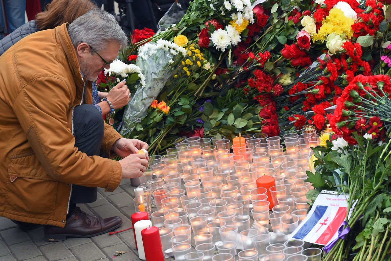 People leave flowers and candles outside the French embassy in Moscow on Nov. 14, 2015.