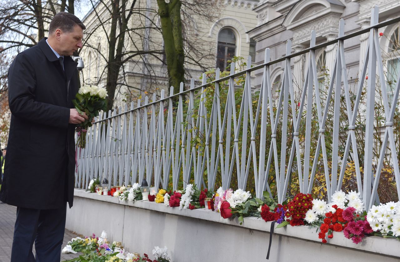 Latvian President Raimonds Vejonis places flowers in front of the French embassy in Riga, Latvia, on Nov. 14, 2015.