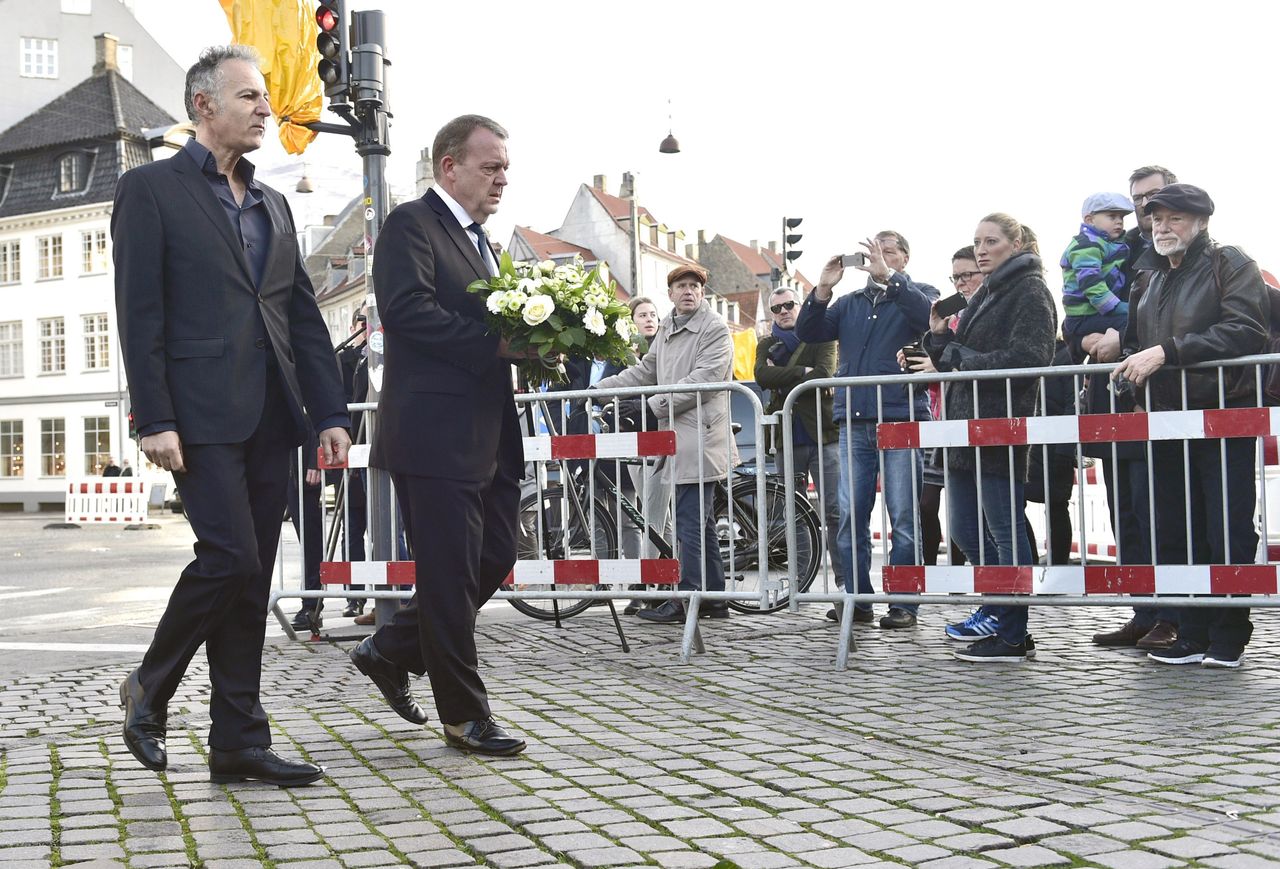 Danish Prime Minister Lars Loekke Rasmussen (second from left) and the French ambassador to Denmark Francois Zimeray arrive to lay flowers in front of the French embassy in Copenhagen on Nov. 14, 2015.