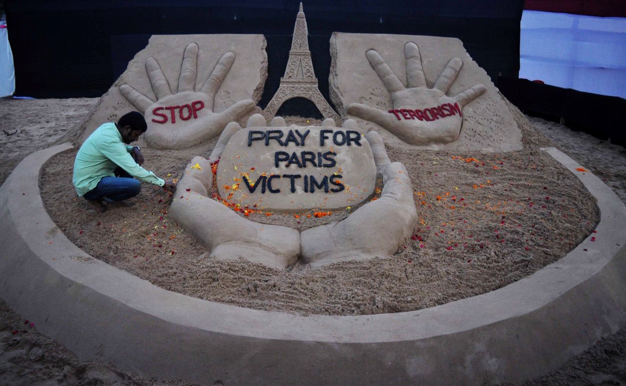 An Indian sand artist finishes a sculpture in Bhubaneswar, made in tribute to the victims of a series of terror attacks in Paris, on Nov. 14, 2015.