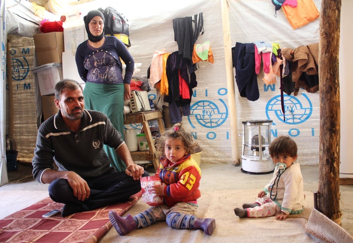 A Yazidi family of four in the makeshift shelter they hope to soon leave when they return to Sinjar.