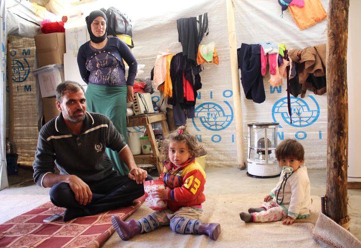 A Yazidi family of four in the makeshift shelter they hope to soon leave when they return to Sinjar.