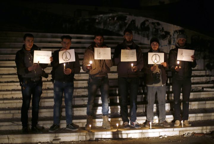 Syrians hold a vigil to pay respect to the victims of the attacks in Paris on Saturday in Douma, in eastern Ghouta, a rebel stronghold east of the Syrian capital Damascus.