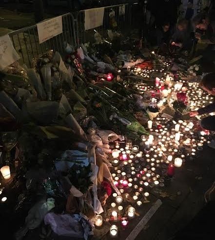Flowers and candles lines the streets outside the Bataclan in Paris on Saturday.