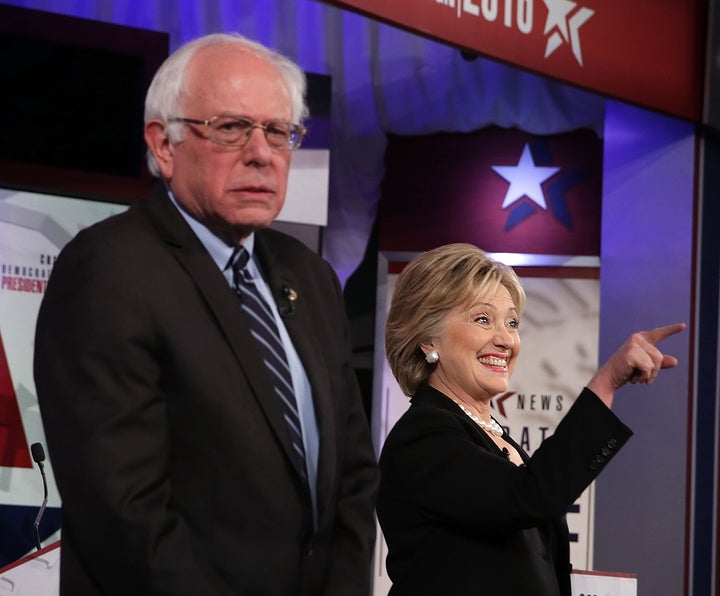 Democratic presidential candidates Sen. Bernie Sanders (I-Vt.) and Hillary Clinton stand on the stage prior to the presidential debate. Sanders still doesn't want to hear any more about the emails.