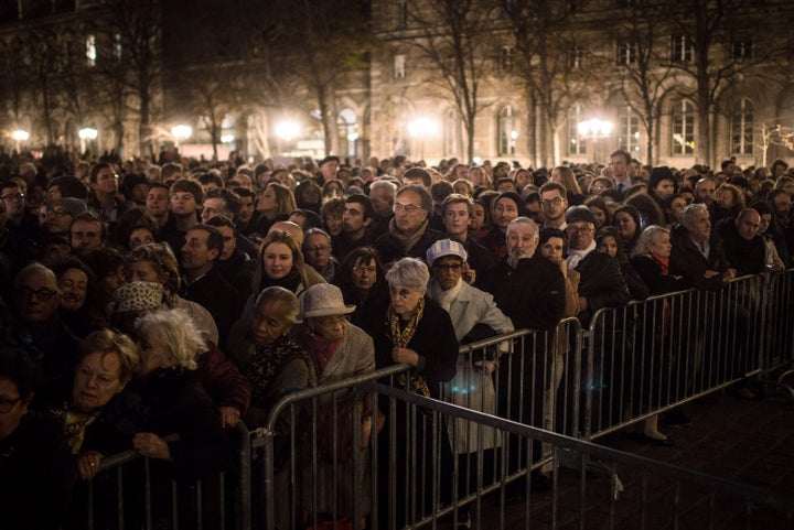 People gather outside of Notre Dame cathedral on Nov. 15, 2015, ahead of a ceremony to the victims of Friday's terrorist attacks in Paris.