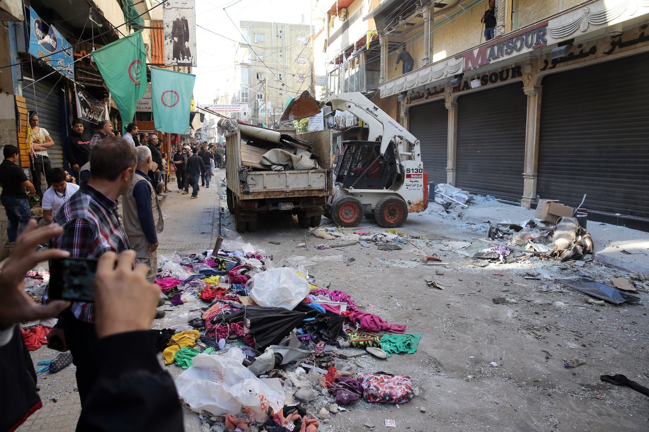 A relative of Samer Huhu, who was killed in a twin bombing attack that rocked a busy shopping street in the area of Burj al-Barajneh, waves his portrait as she mourns during his funeral in the southern suburb of the capital Beirut on November 13, 2015. Lebanon mourned 44 people killed in south Beirut in a twin bombing claimed by the Islamic State group, the bloodiest such attack in years, the Red Cross also said at least 239 people were also wounded, several in critical condition.