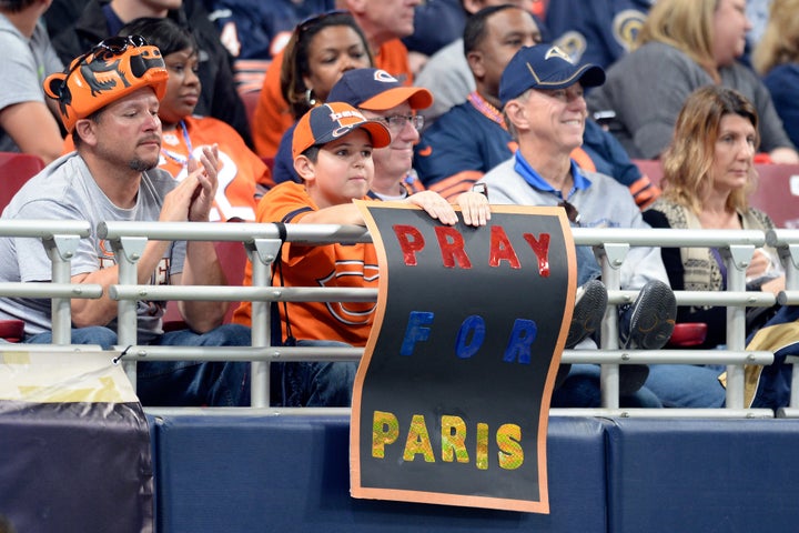 A young fan at the Edward Jones Dome in St. Louis, Missouri, displays a sign in support for the people of Paris during the second half of a game between the Chicago Bears and the St. Louis Rams.