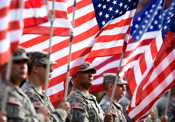 The Colorado National Guard stands for a moment of silence before the Denver Broncos faced off against the Kansas City Chiefs at Sports Authority Field at Mile High in Denver, Colorado.