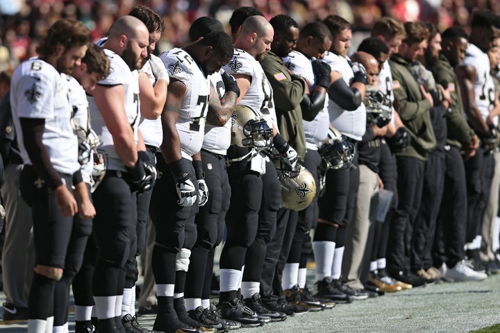 New Orleans Saints players participate in a moment of silence before playing the Washington NFL team at FedExField in Landover, Maryland.