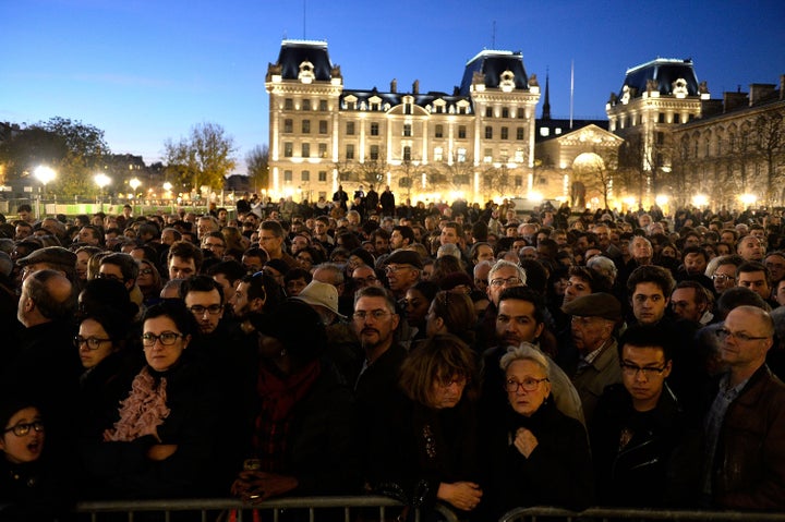 People gather outside Notre Dame Cathedral in Paris on Nov. 15 ahead of a ceremony for the victims of Friday's terrorist attacks.