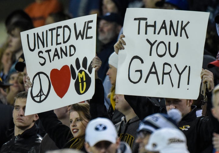 Fans hold up signs showing support for the Missouri Tigers, the University of Missouri and head coach Gary Pinkel on Nov. 14, 2015.