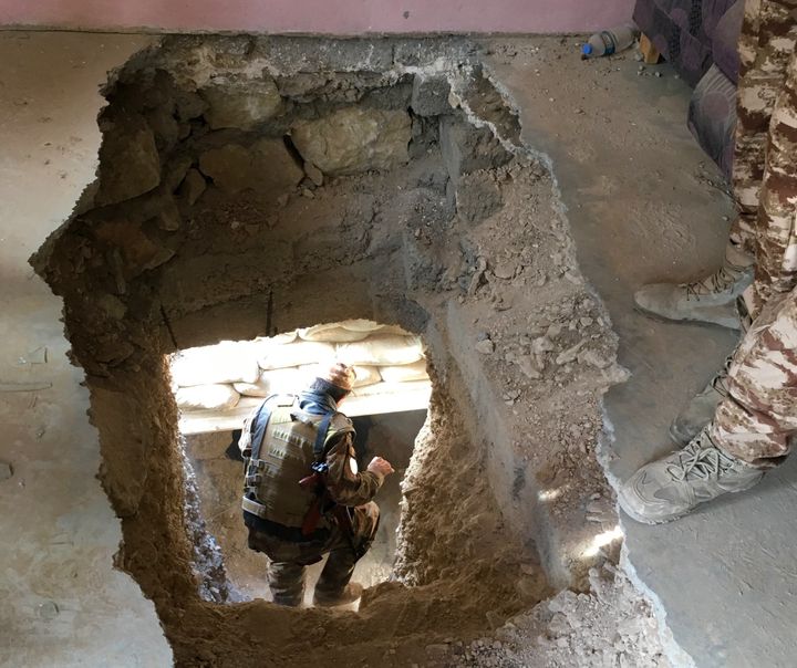 A Yazidi member of the local Asayesh security forces heads down an ISIS tunnel beneath a house in Sinjar, Iraq, which the extremist fighters controlled until Kurdish forces, backed by U.S. airstrikes, forced them out this month.