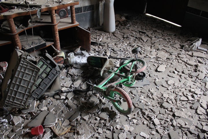 A child's tricycle in the burnt remains of a Yazidi family home in Sinjar, Iraq. 