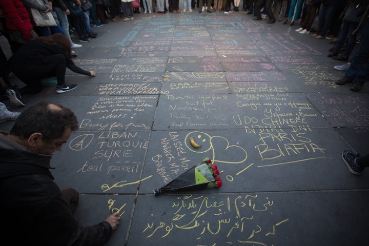 Mourners gathered at Place de la Republique to write tributes for slain victims.