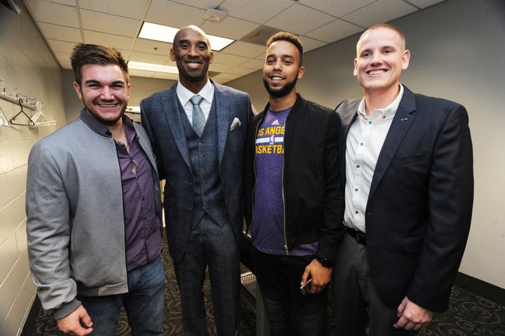 Kobe Bryant #24 of the Los Angeles Lakers poses with Spencer Stone, Alek Skarlatos and Anthony Sadler before the game against