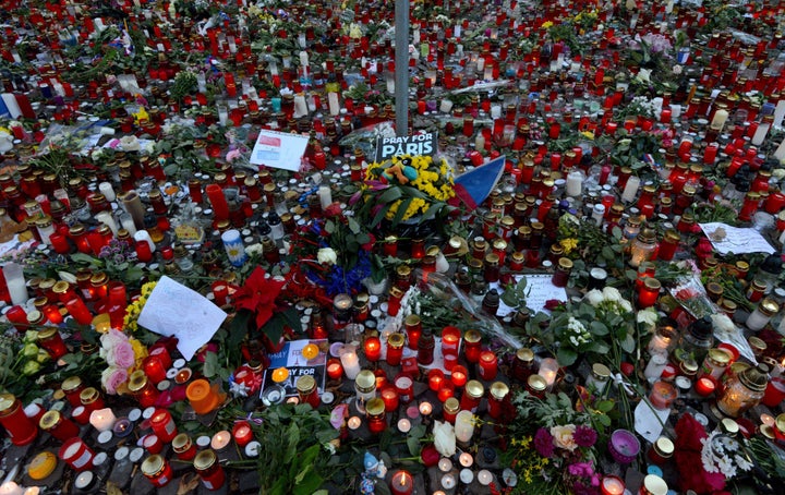 Candles and flowers are placed in front of the French embassy in Prague as part of an international outpouring of grief and sympathy for France.