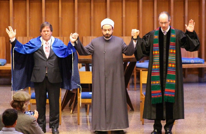 Rabbi Schnitzer, Dr. Tarek Elgawhary and Pastor David Gray pray together during an interfaith service at Bradley Hills Presbyterian Church in Bethesda, Maryland.