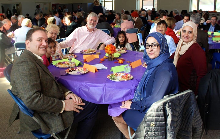 People gathered at Bradley Hills Presbyterian Church share a meal together following the interfaith service.