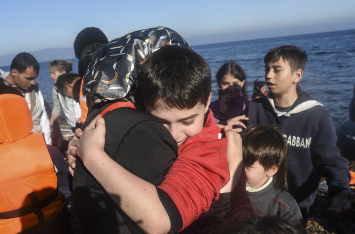 A Syrian family arrive with other migrants and refugees on the Greek island of Lesbos after crossing the Aegean Sea from Turk