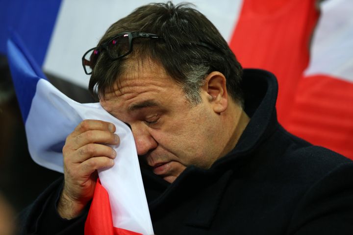 A French fan wipes away his tears during the national anthem before the international friendly between England and France at Wembley Stadium.
