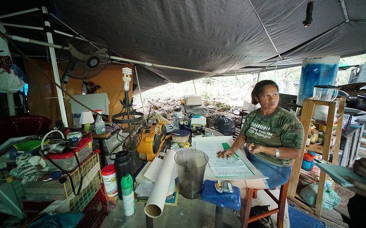 Loke lives with her husband in a shelter built from metal pipes and overlapping tarps. The structure partially collapsed during rainstorms earlier in the month.