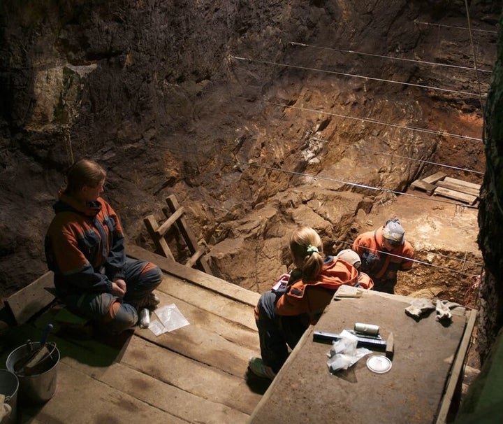 Researchers in the cave where the Denisovan fossils were found.