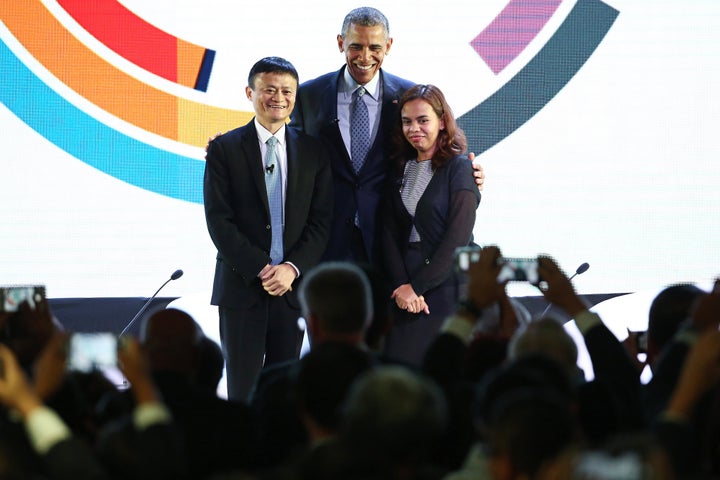 Obama, center, poses for a photograph with billionaire Jack Ma, left, and engineer Aisa Mijeno, co-founder of Salt (Sustainable Alternative Lighting). 