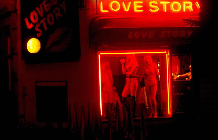 Cheb, CZECH REPUBLIC: Prostitutes wait for clients behind a window of a brothel 14 December 2006 on a highway near the city of Cheb located on western Czech-German border. Between five and 10 percent of women victims of human trafficking in the Czech Republic are under age, according to a 2004 report by the Czech Institute of Criminology (IKSP).