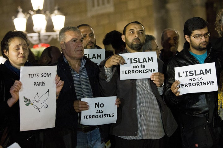 Muslims from Spain gather to condemn Friday terror attacks in Paris by lighting candles at Placa Sant Jaume in Barcelona.