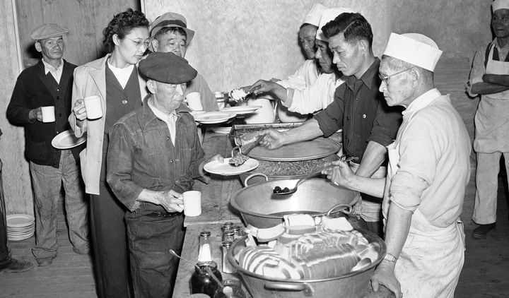 Japanese-Americans removed from their Los Angeles homes line up at the governments alien camp at Manzanar, California, on March 23, 1942, for their first meal after arrival at the camp.