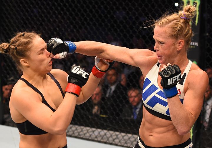Holm punches Rousey in their UFC women's bantamweight championship bout in Melbourne, Australia.