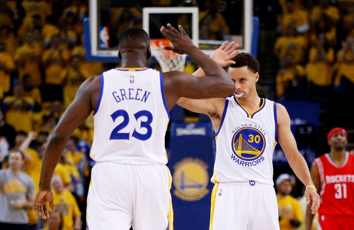 Point forward Draymond Green and reigning league MVP Stephen Curry (right) are both enjoying stellar seasons thus far.