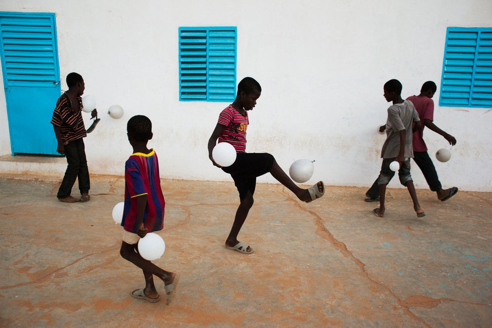 A group of boys play soccer with balloons after attending a dance recital about water scarcity in the city of Kaedi in the Go
